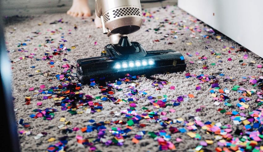 A vacuum cleaner on the carpet.