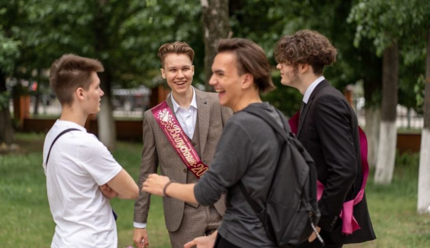 A group of young men talking in a park.