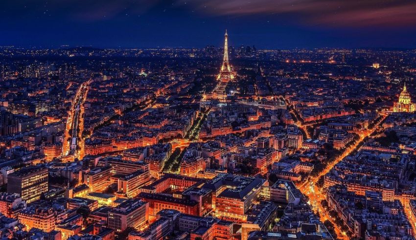 Paris at night with the eiffel tower in the background.
