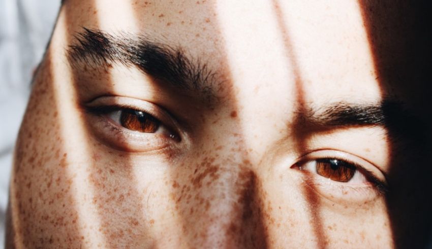 A close up of a man's face with freckles.