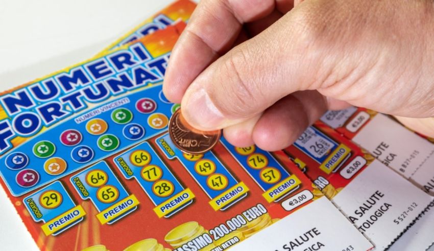 A person holding a lottery ticket and a coin.