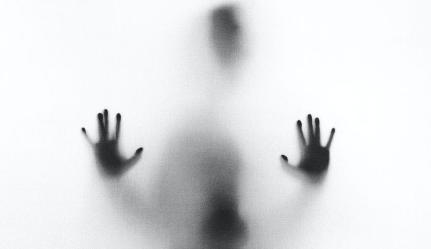 A black and white photo of a person with hands outstretched.