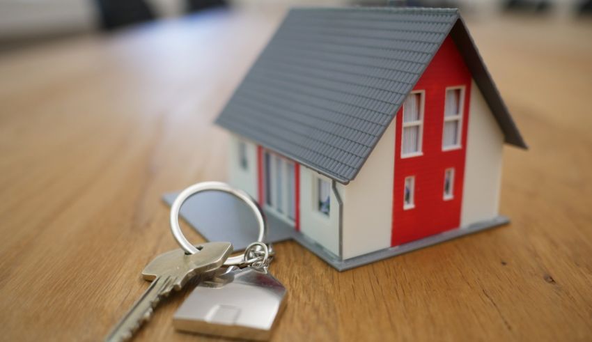 A house and key on a table.