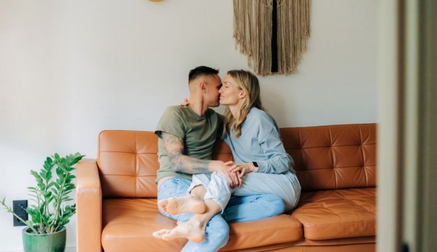 A couple sitting on a couch in a living room.