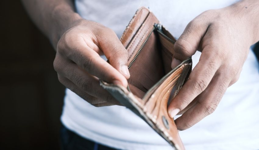 A man's hands holding an empty wallet.