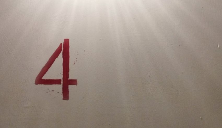 The number four is painted on a wall.