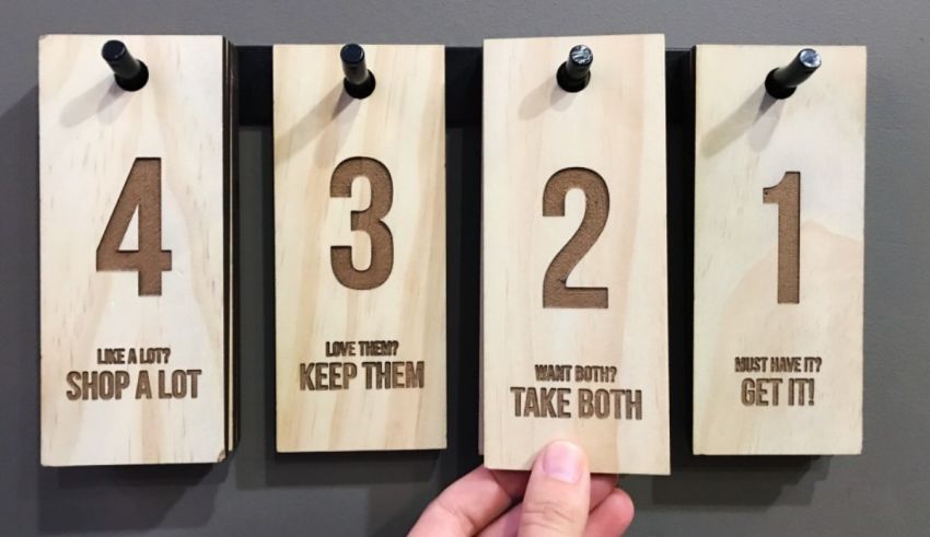 Four wooden hangers with numbers on them.