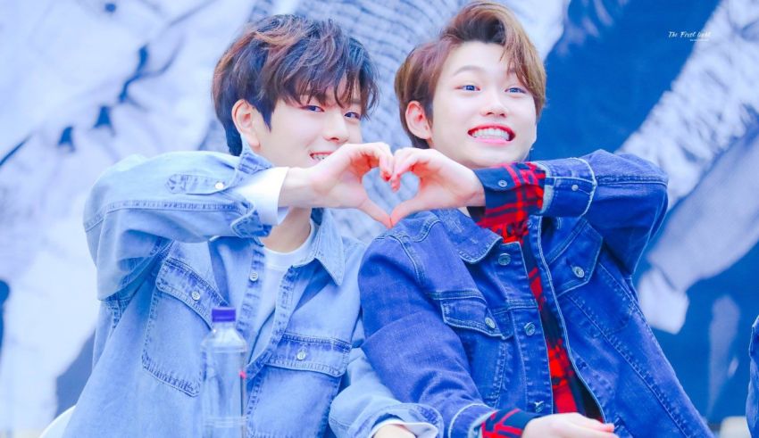 Two korean boys making a heart shape with their hands.