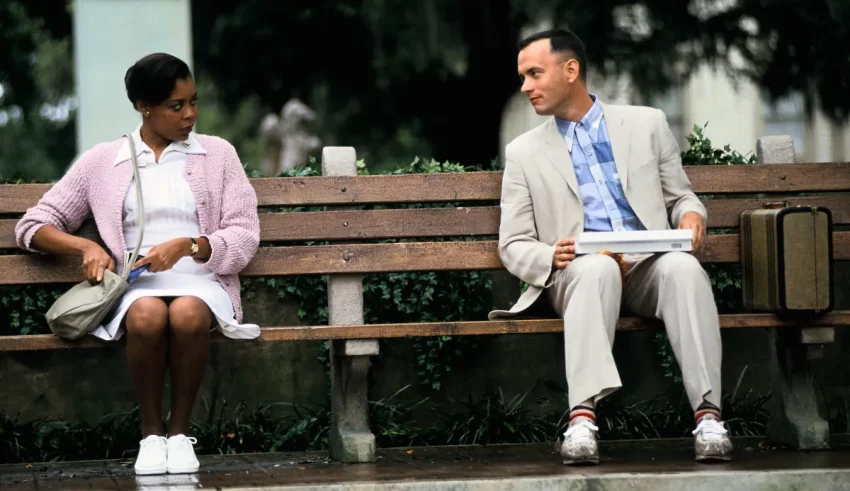 A man and woman sitting on a bench.