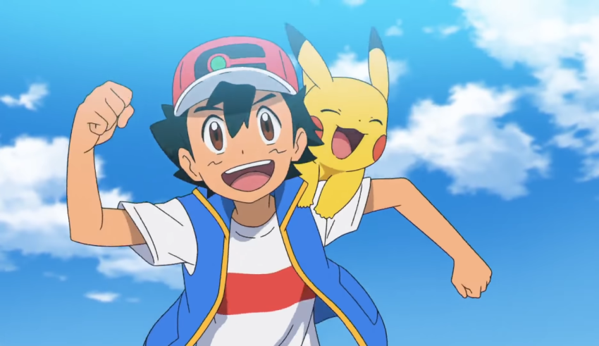 A boy is holding a pokemon in his arms.