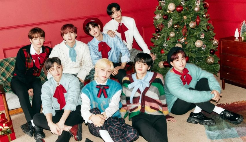 A group of boys posing in front of a christmas tree.