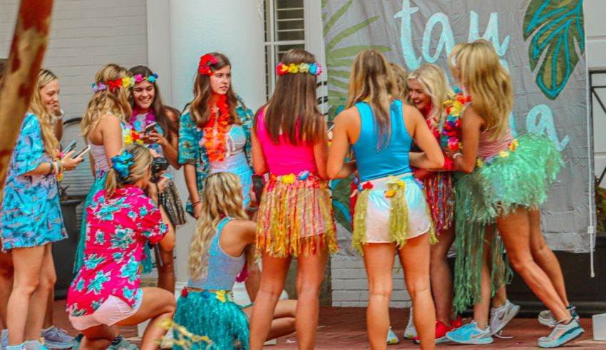 A group of girls dressed up in hawaiian outfits.