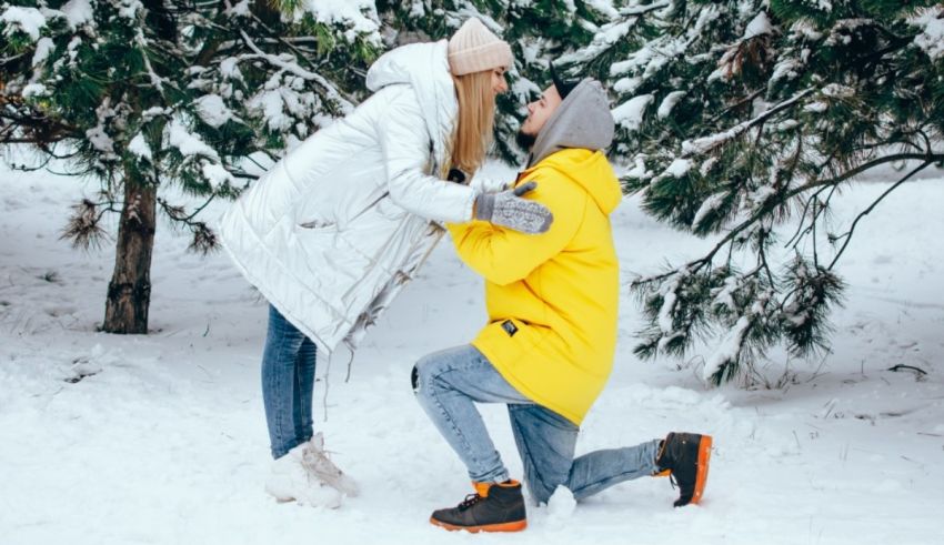 A man is proposing to a woman in the snow.