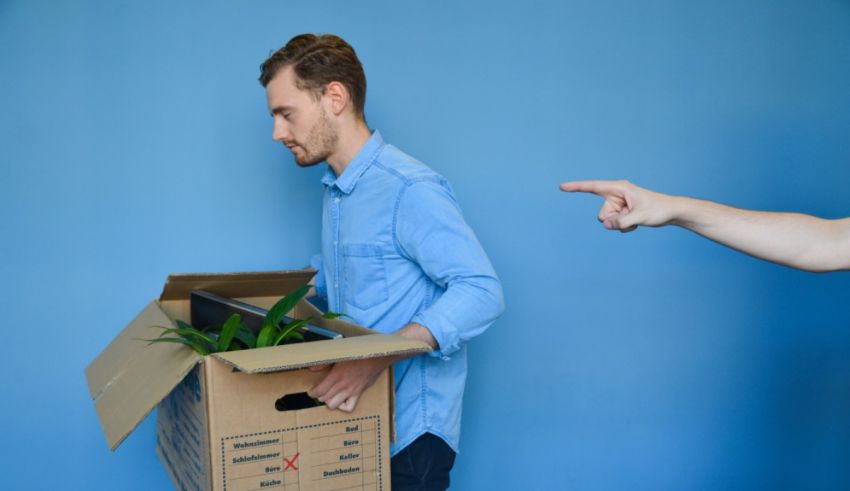 A man is pointing to a box while another man is pointing to a box.