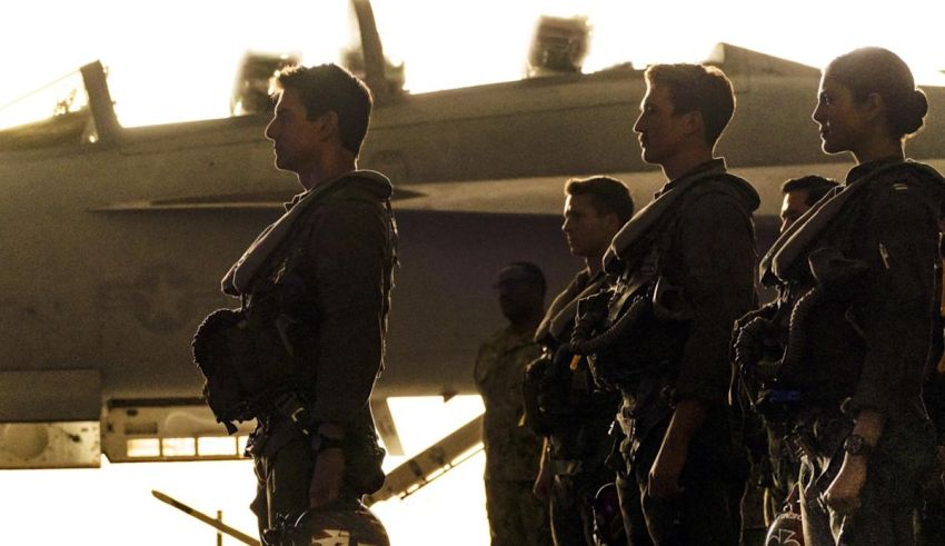 A group of soldiers standing in front of a plane.