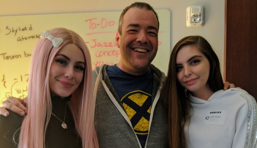 A man with pink hair and a woman with pink hair posing for a photo.