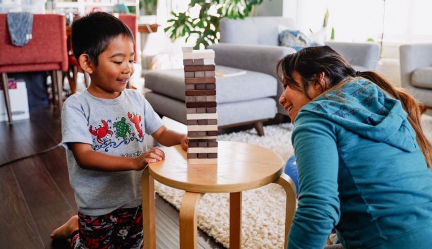 A mother and child playing with wooden blocks in a living room.