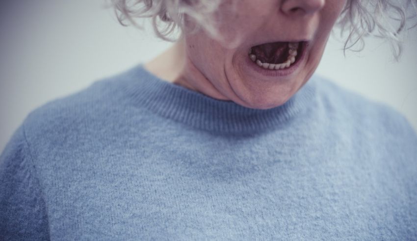 A woman is yelling with her mouth open.