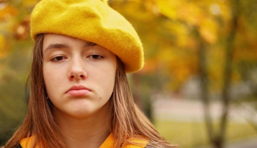 A young girl wearing a yellow beret.