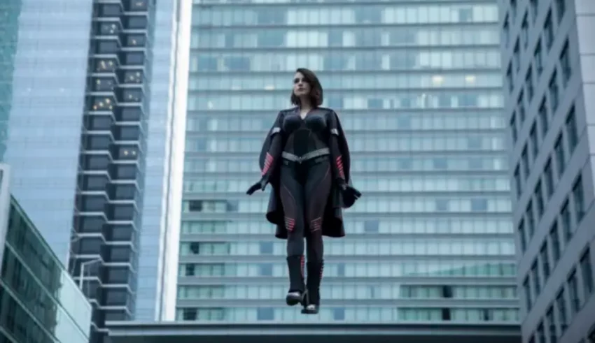 A woman is flying in the air over a city.