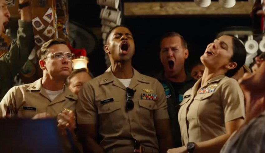 A group of people in military uniforms singing in a bar.