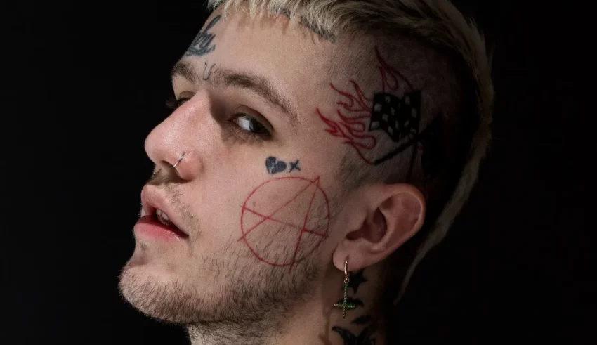 A young man with tattoos on his face.