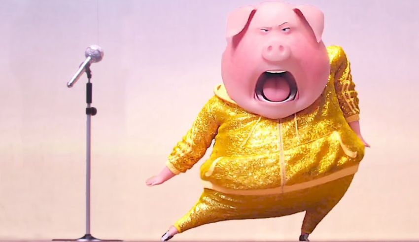 A pig in a gold suit singing into a microphone.