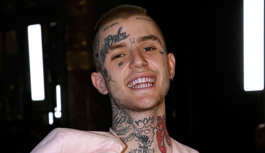 A man with tattoos smiling for the camera.