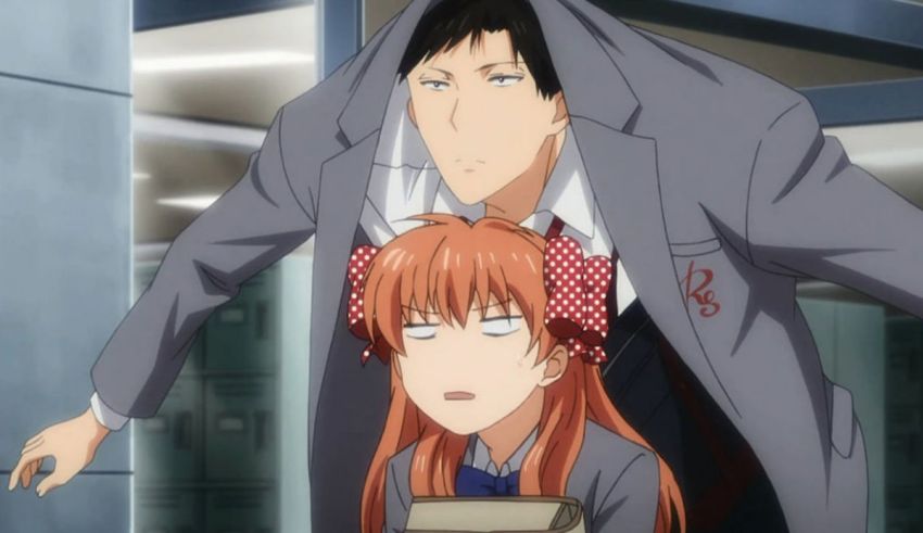 A man in a suit and a woman with red hair.