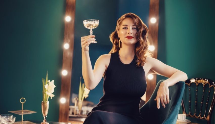 A woman holding a glass of wine in front of a mirror.