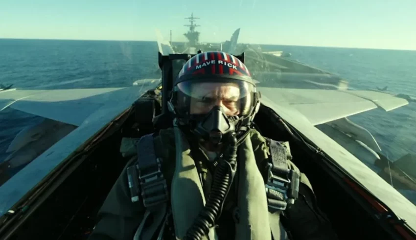 A man in a helmet is flying a fighter jet.