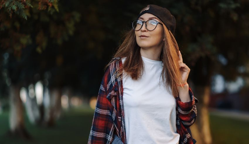 A young woman wearing glasses and a plaid shirt.