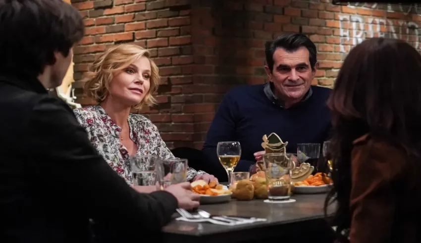 A group of people sitting at a table with food.