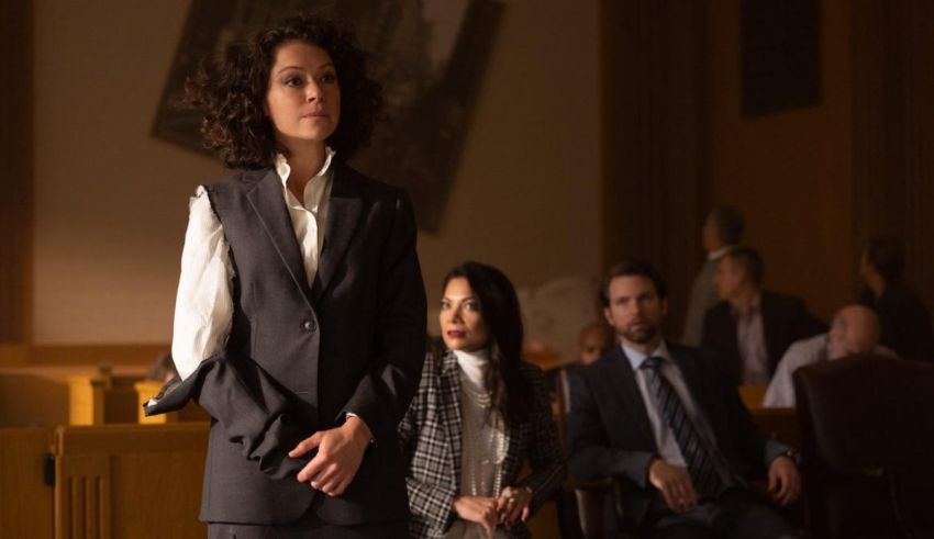 A woman in a suit standing in a courtroom.