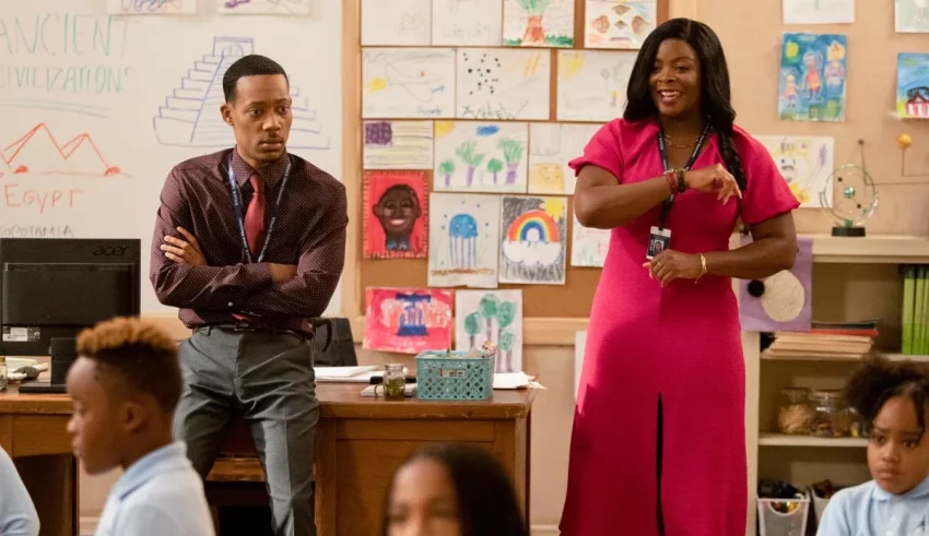 A man and woman standing in front of a classroom.