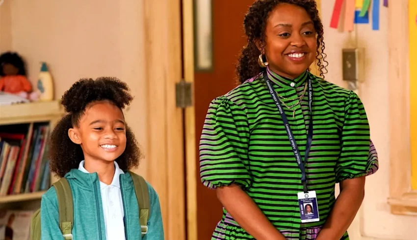 A woman and a young girl standing in a classroom.