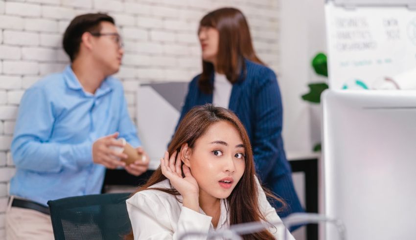 Asian woman looking at her phone in the office.