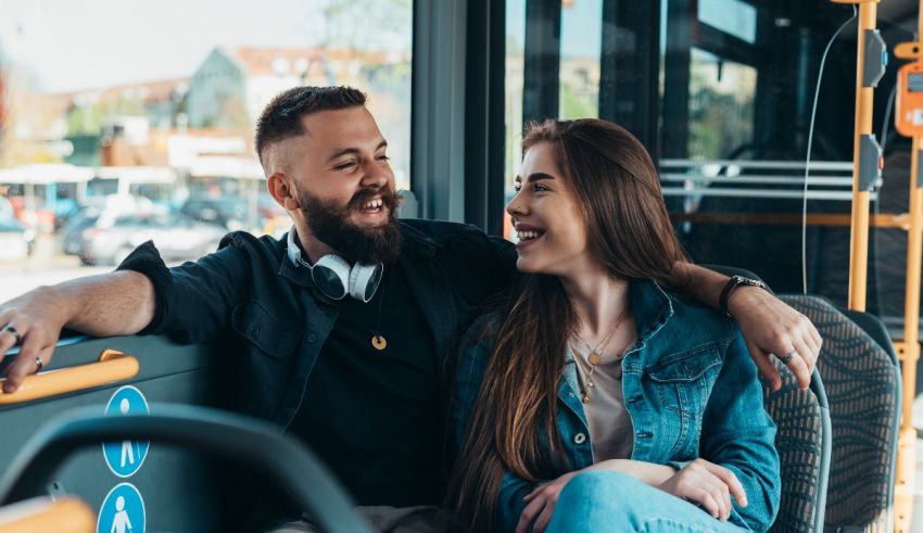 A man and a woman sitting on a bus.