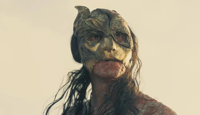 A woman with a gold mask on her face.