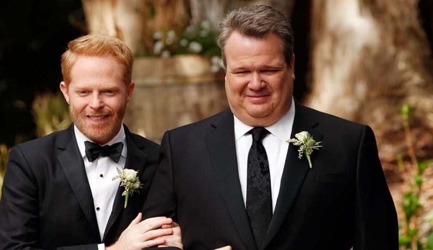 Two men in tuxedos standing next to each other.