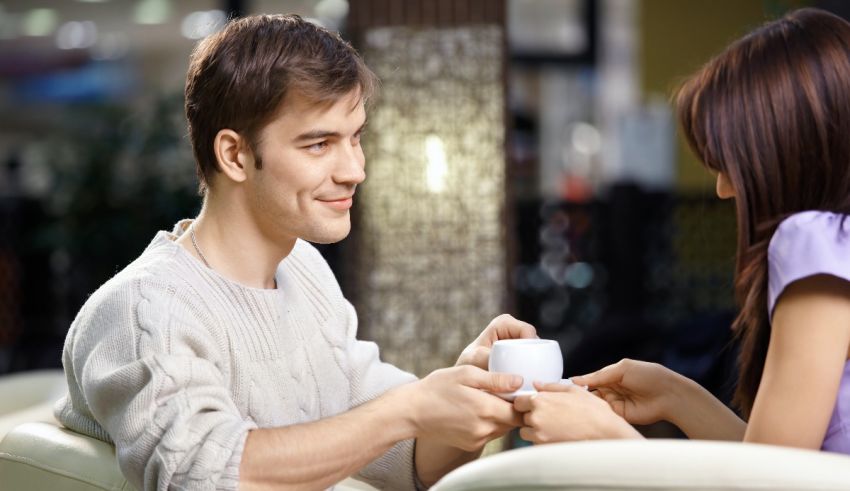 A man and woman holding a cup of coffee.
