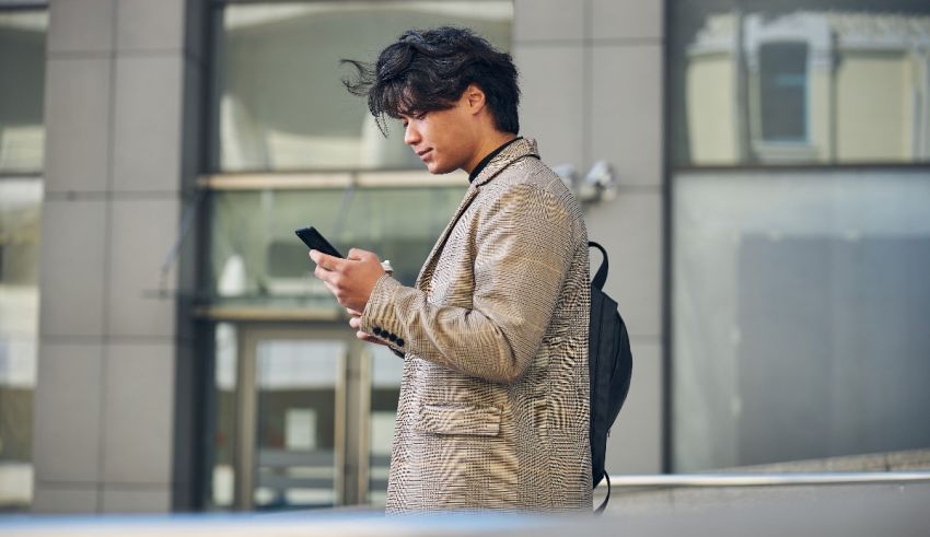 Young asian man looking at his cell phone.