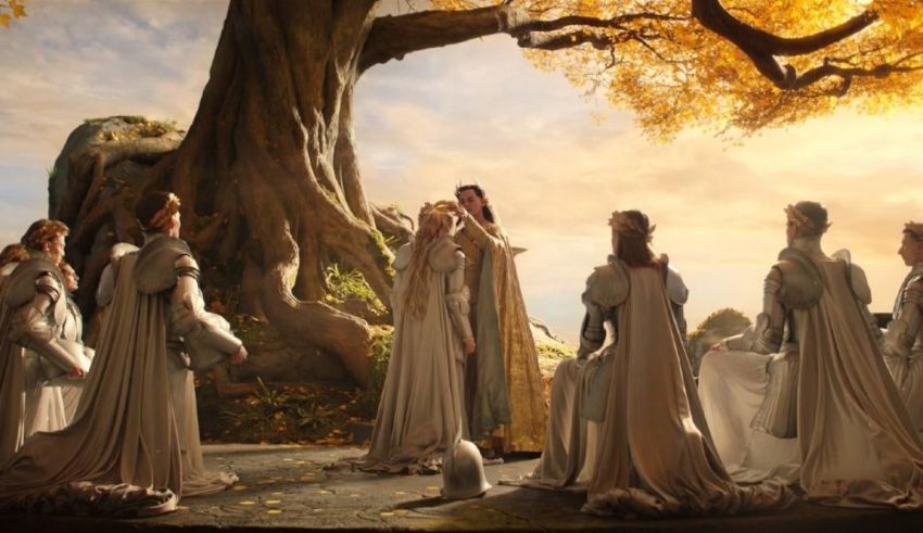 A group of women dressed in white are standing in front of a tree.