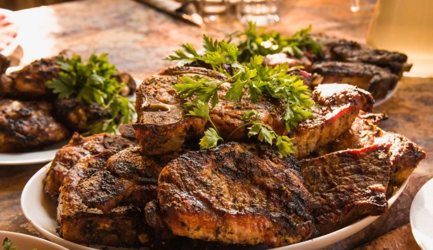 Grilled pork chops on a wooden table.