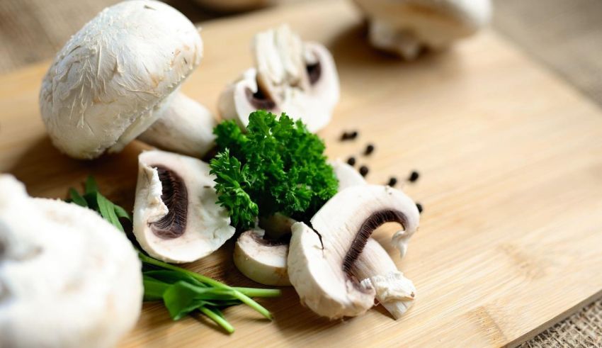 Mushrooms and parsley on a cutting board.