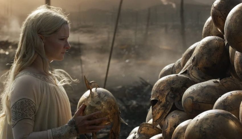 A woman is standing next to a pile of helmets.