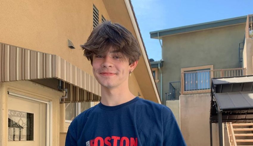 A young man wearing a boston red sox t - shirt.