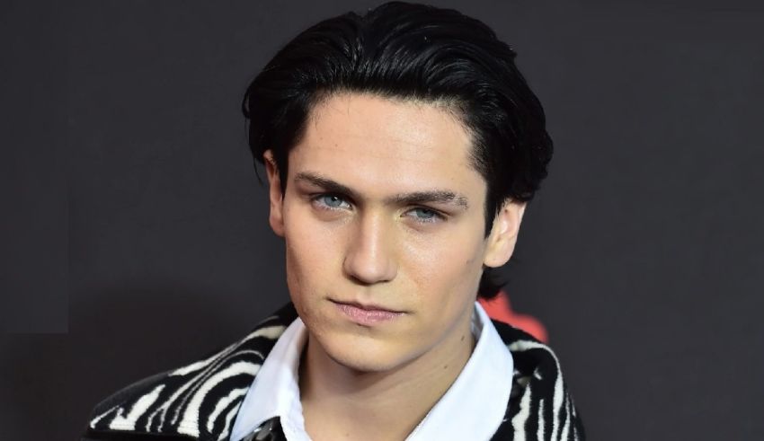 A young man wearing a zebra print jacket.