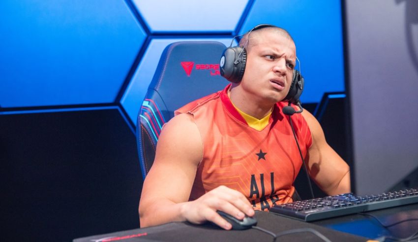 A man sitting in front of a computer with headphones on.