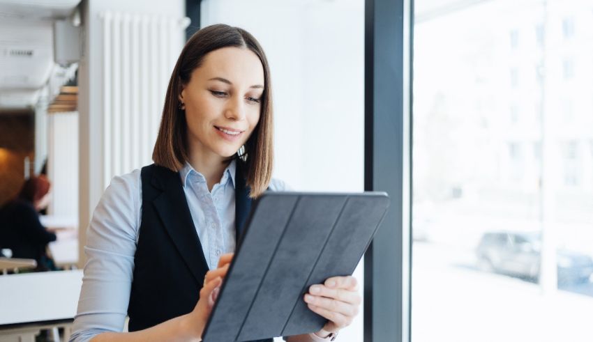 A business woman using a tablet computer in an office.